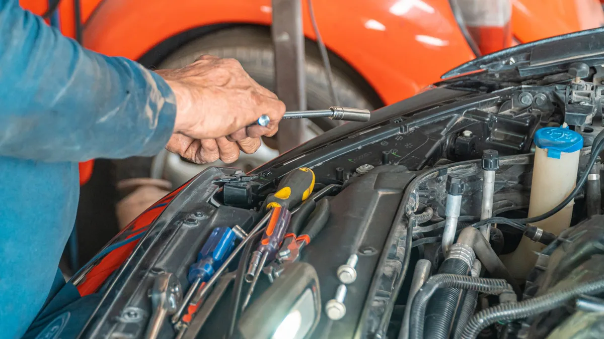 A technician working in an auto body repair shop