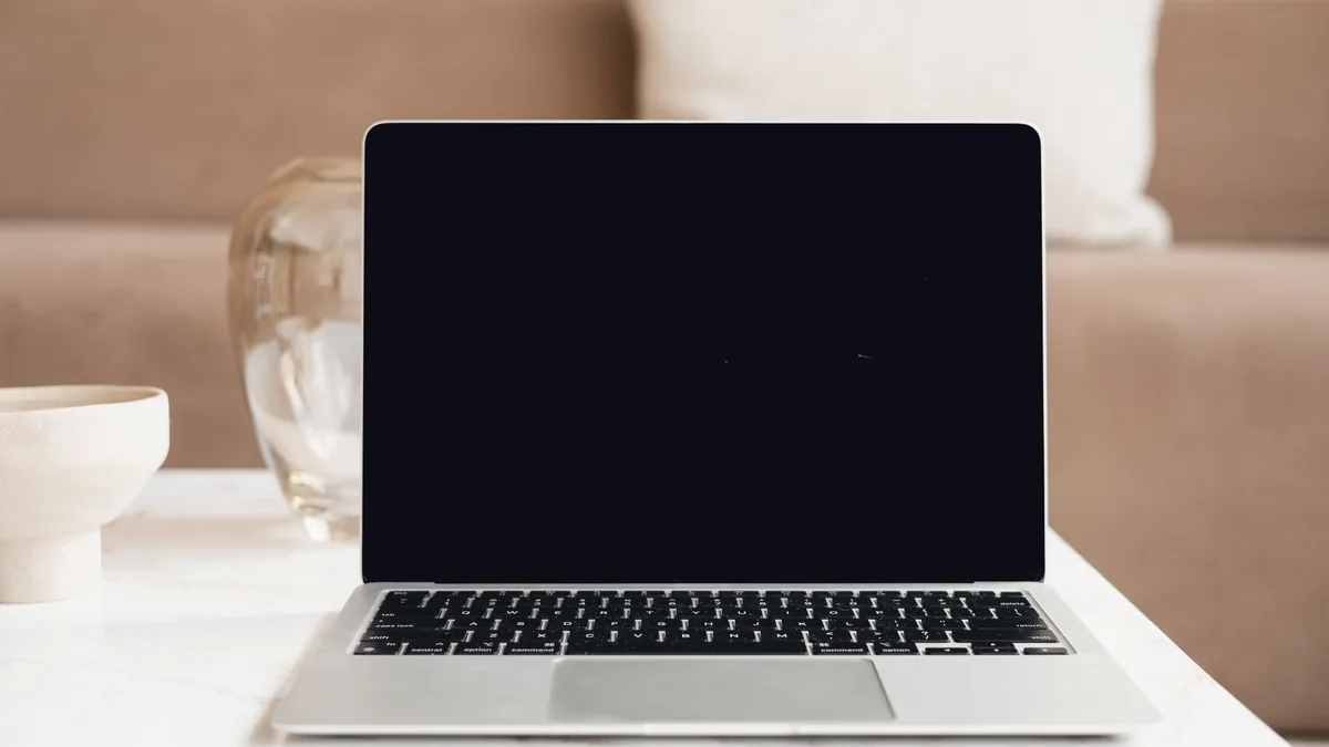 A web designer working on a website layout on a laptop